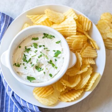 Homemade Chip Dip in white bowl with ruffled potato chips