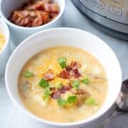 Bowl of Instant Pot Potato Soup Topped with Bacon and cheese