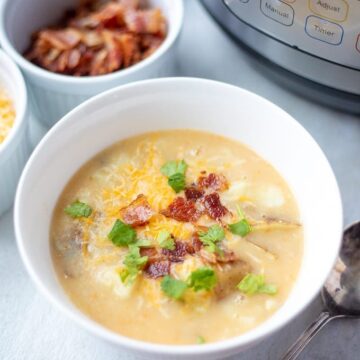 Bowl of Instant Pot Potato Soup Topped with Bacon and cheese