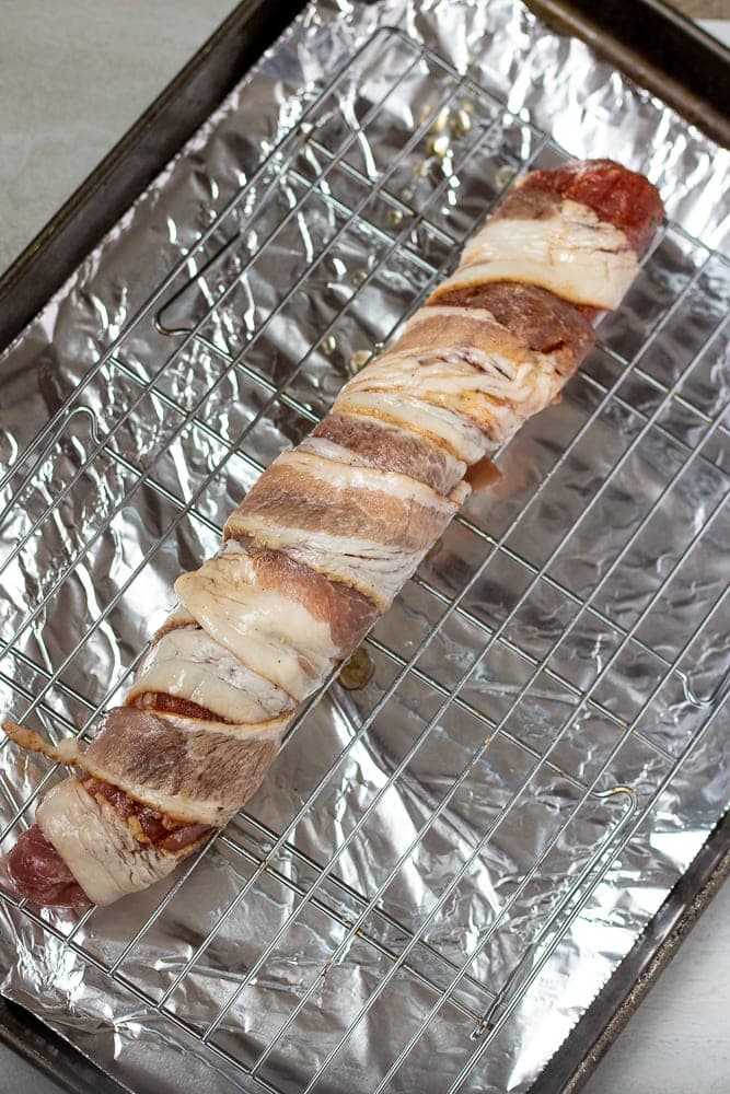Bacon Wrapped Tenderloin on oven baking sheet lined with foil.