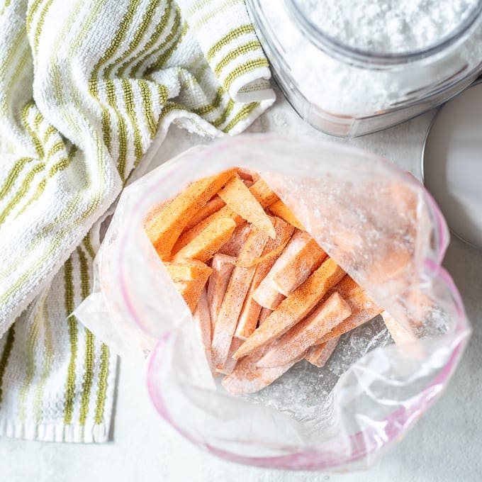 Sweet Potato Fries in bag being coated with cornstarch