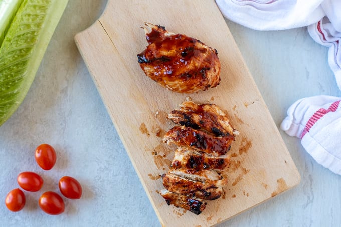 Grilled BBQ Chicken Sliced on Cutting Board