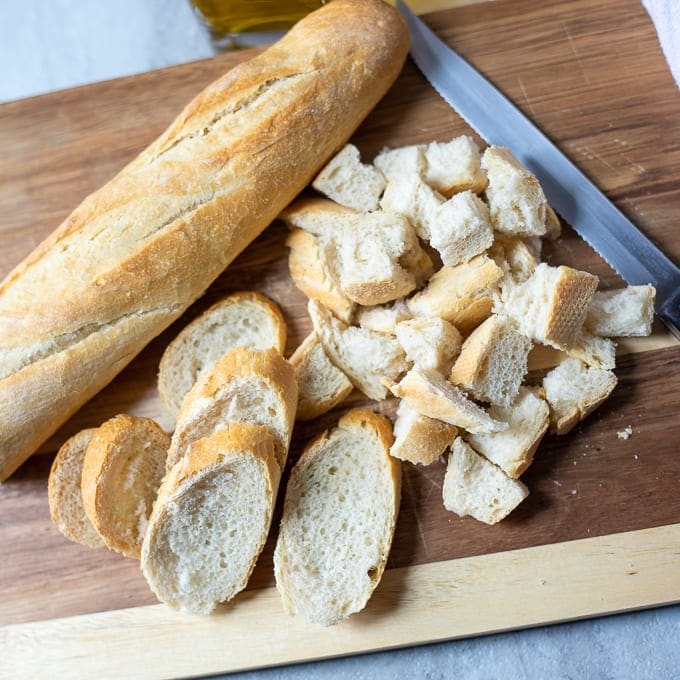 Loaf of Italian Bread on cutting board with knife.