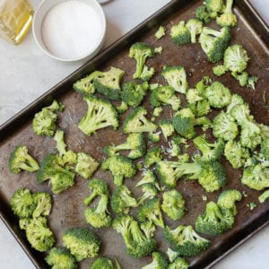 Seasoned Broccoli Spread out on Roasting Pan