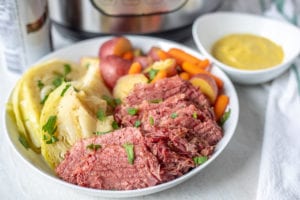 Corned Beef, Cabbage, Potatoes and Carrots in white serving platter
