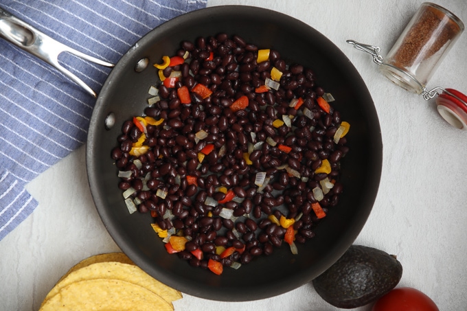 Black Beans in saute pan with peppers and onions