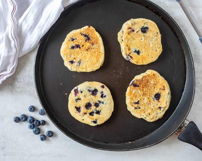 Vegan Blueberry Pancakes on Griddle pan.
