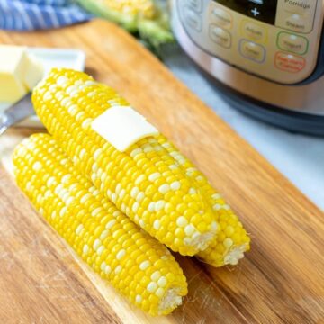 Corn on the Cob with Butter next to Instant Pot