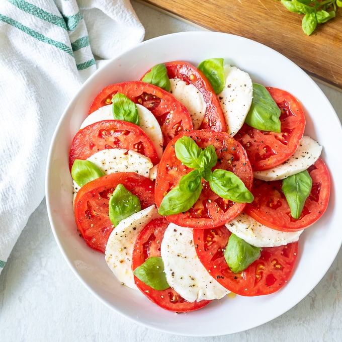 Mozzarella and Tomato Salad in white bowl.