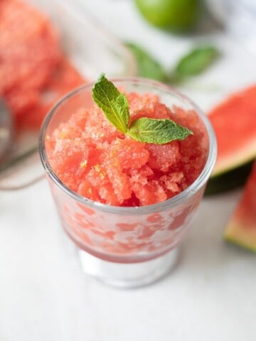 Watermelon Granita in glass bowl with mint leaves and mint sugar