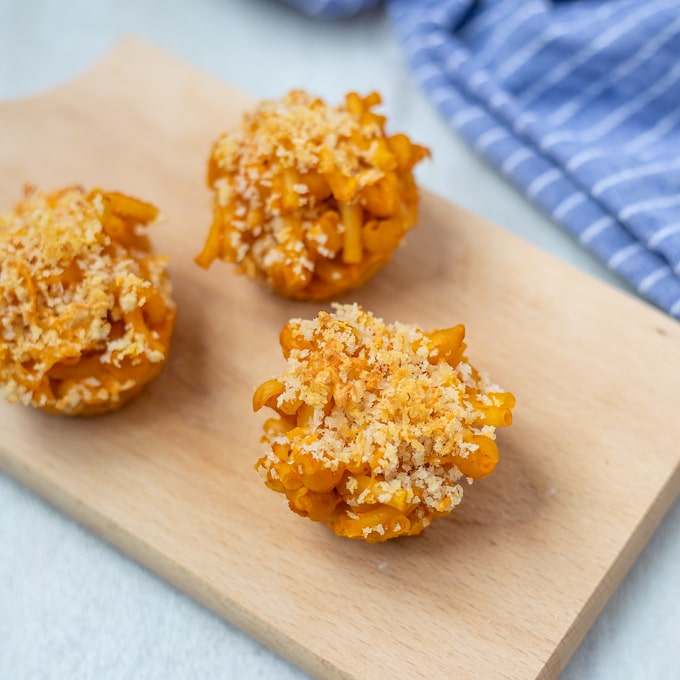 3 Mac and cheese muffins on cutting board