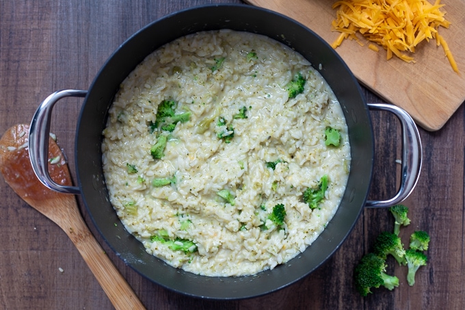 Saucepan with broccoli, rice, in a creamy cheese sauce.