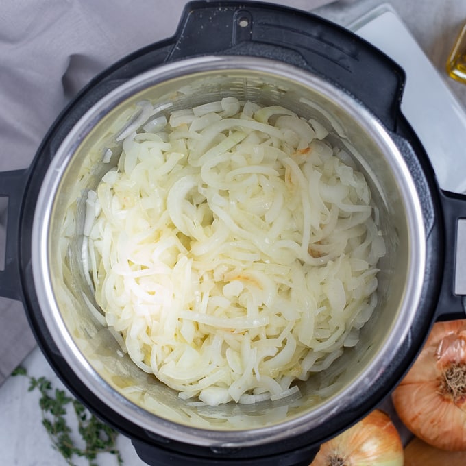Onions sauted in inner pot of instant pot. 