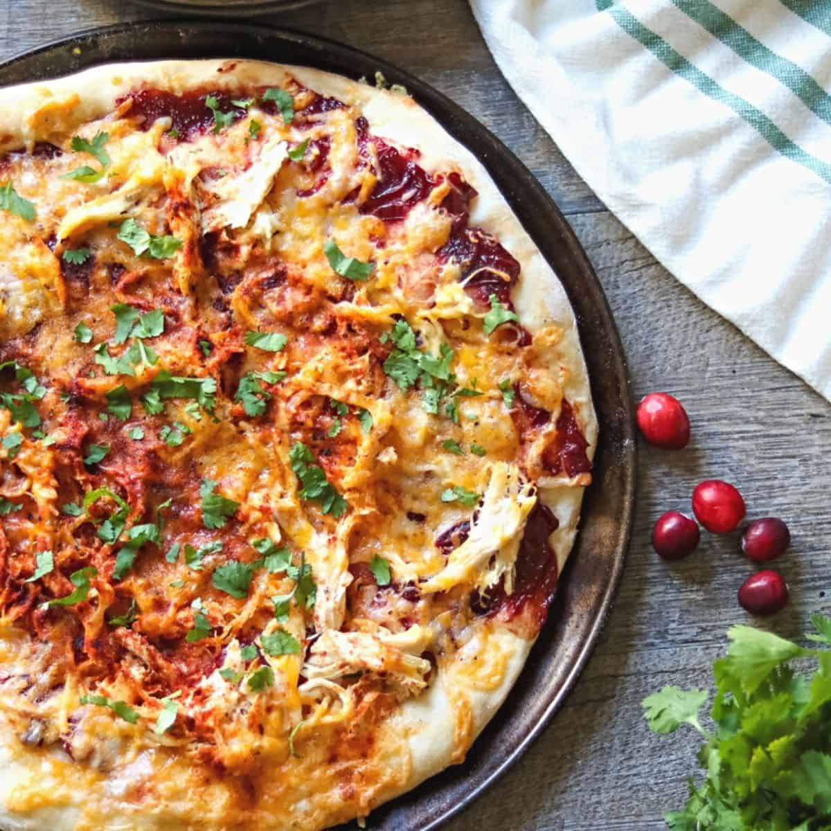 Pizza with Turkey and Cranberry BBQ Sauce on pizza pan.