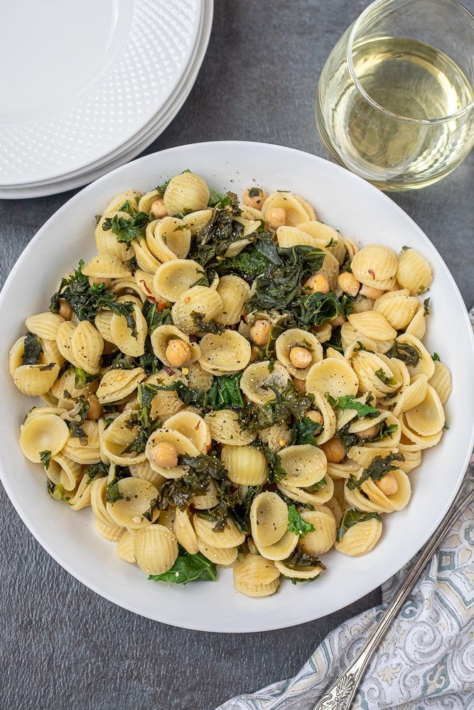 Kale pasta with chickpeas in white bowl