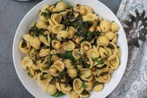 Bowl of pasta with sauteed kale and chickpeas