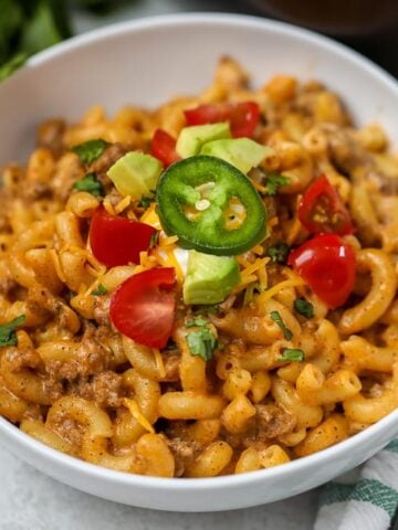 Bowl of Taco Pasta topped with tomatoes and avocado