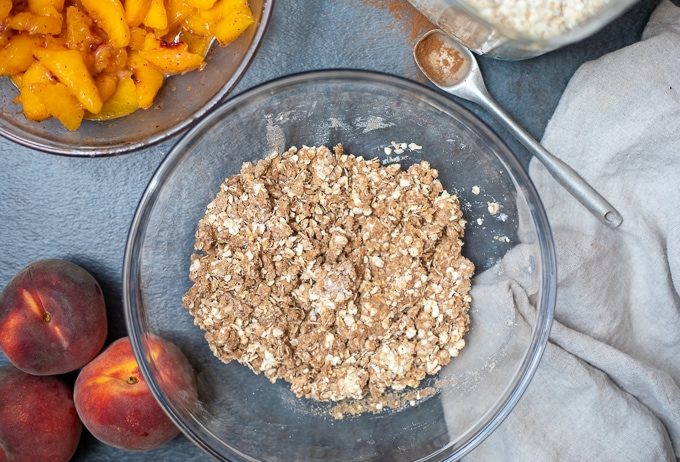 Peach Crisp topping made with oats in mixing bowl.