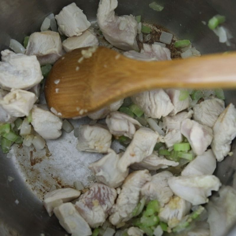 Inner Pot of Instant Pot with chicken, onions, and celery