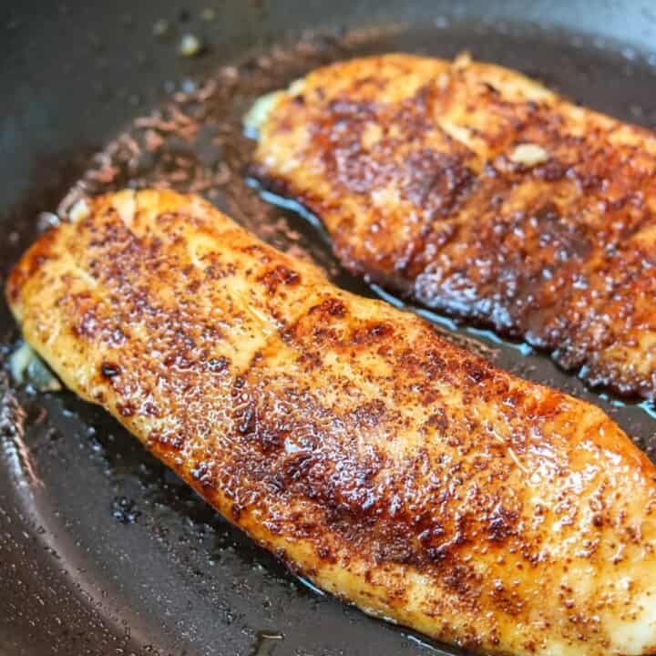 Tilapia in skillet with spice rub.