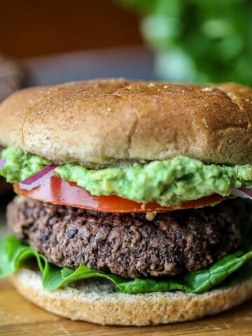 Black Bean Burger with Mashed Avocado on cutting board