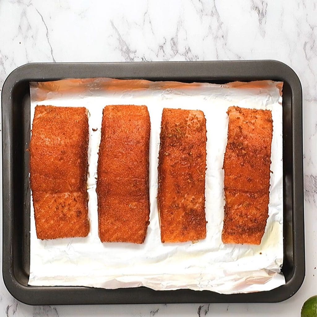Salmon on sheet pan with spice rub.