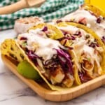 Healthy Fish tacos served with cabbage and crema.