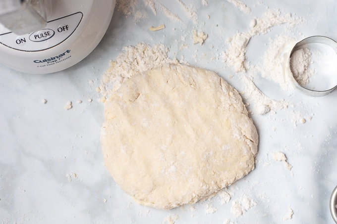 Biscuit dough patted into 1 inch thick oval