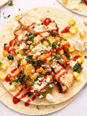 Grilled Chicken Fajita topped with corn salsa and hot sauce.