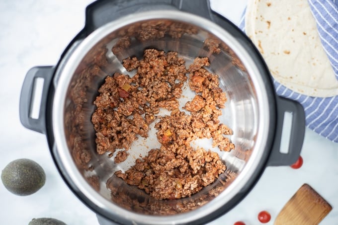 Instant Pot with ground taco meat inside inner pot.