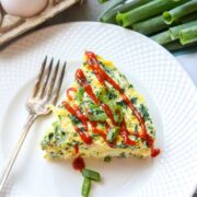 Slice of Spinach Egg Frittata on white plate