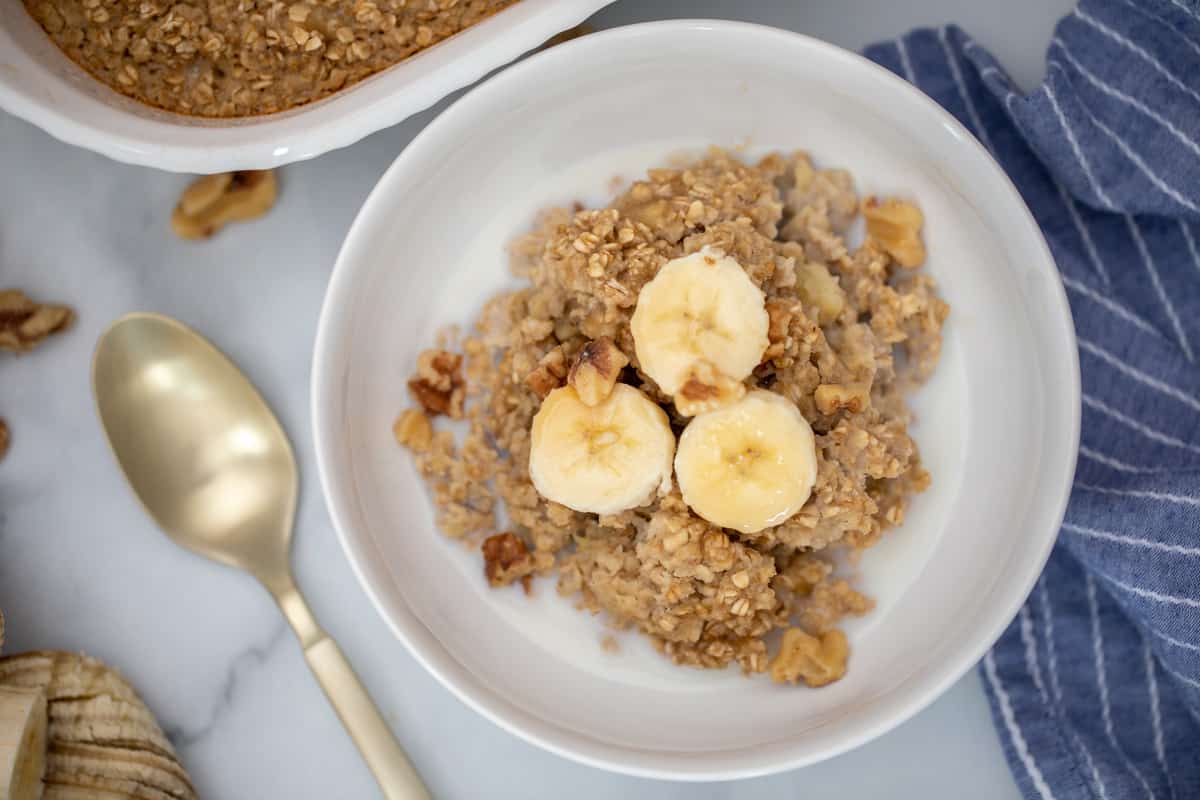 Baked Oatmeal topped with bananas, walnut, and maple syrup.