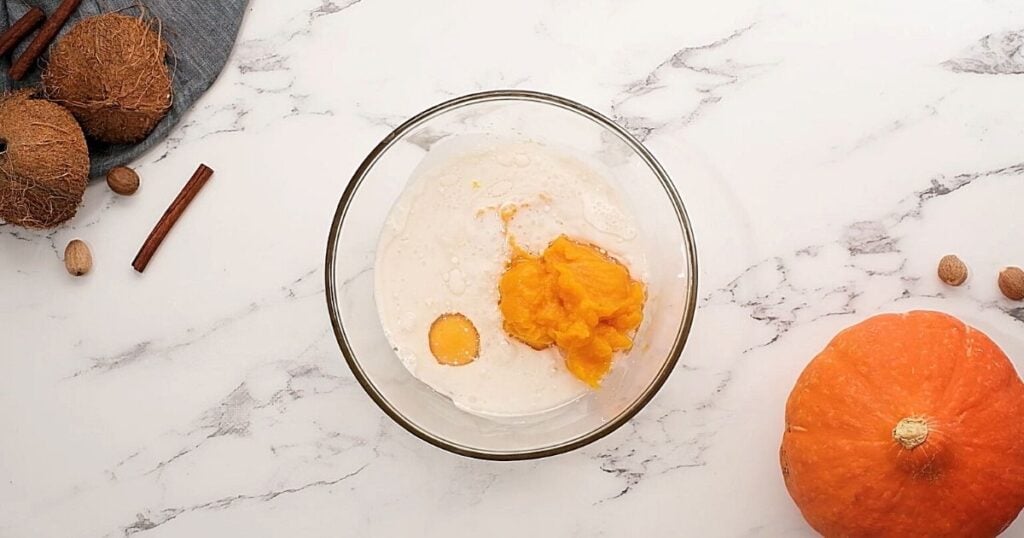 Pumpkin puree, egg, and coconut milk in mixing bowl.