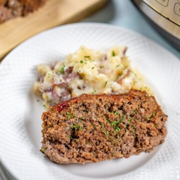 Slice of Meatloaf with mashed potatoes next to Instant pot