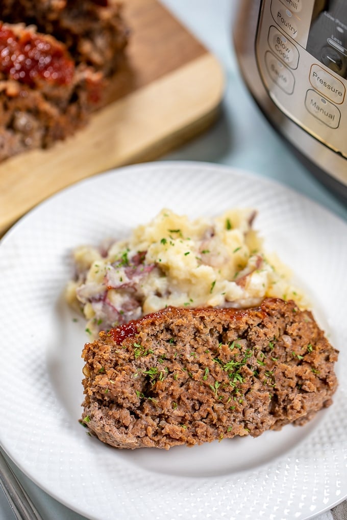 Slice of Meatloaf with mashed potatoes next to Instant pot