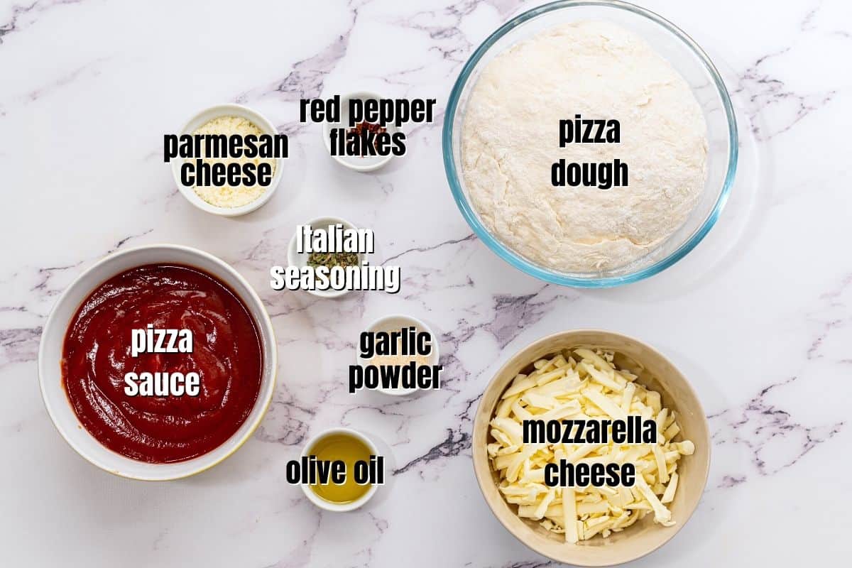 Ingredients for pizza bread labled on counter. 