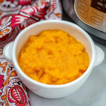 Mashed Instant Pot Butternut Squash in white bowl next to Instant Pot