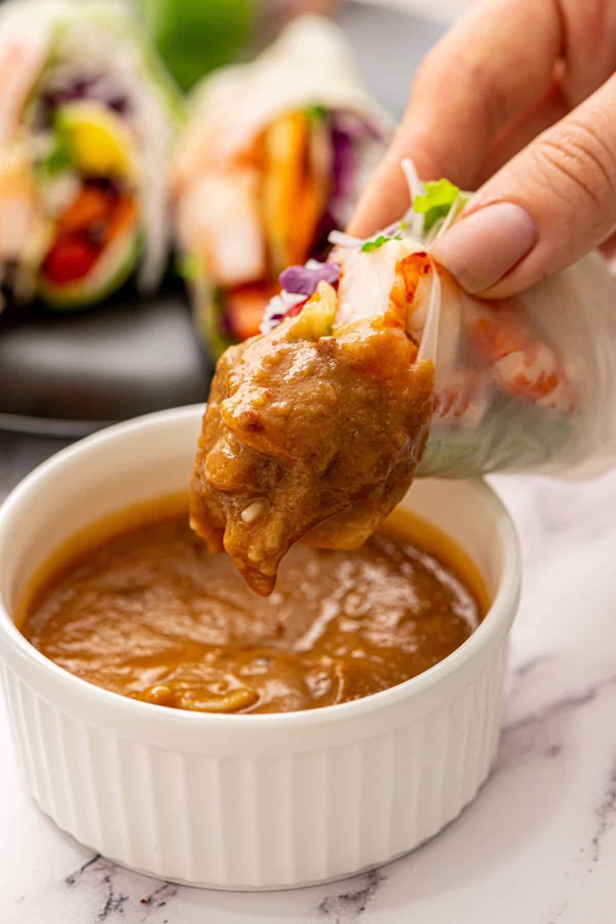 Fresh Spring Roll dipped into Asian Peanut Sauce. 
