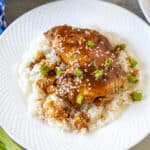 Instant Pot Teriyaki Chicken dished out over white rice on white plate.