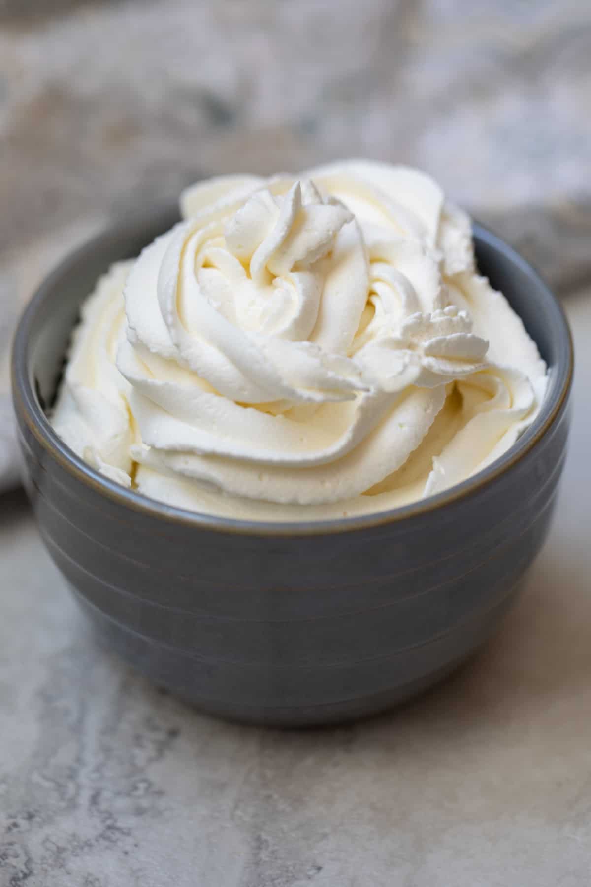 Bowl of piped homemade whipped cream.