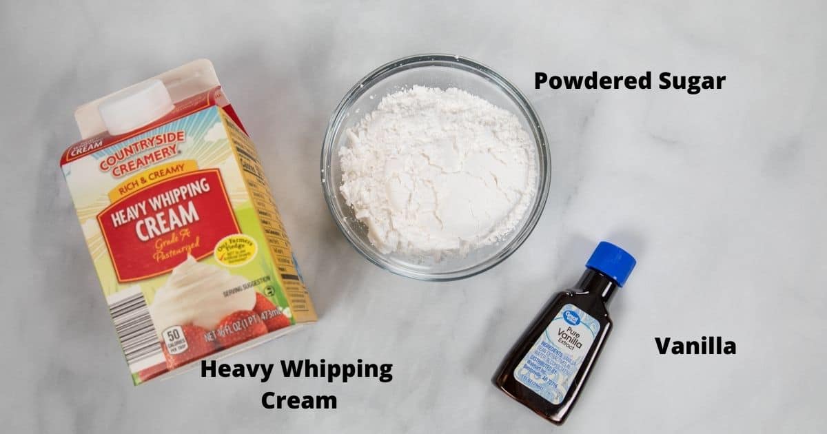 Ingredients for whipped cream labeled on white counter.