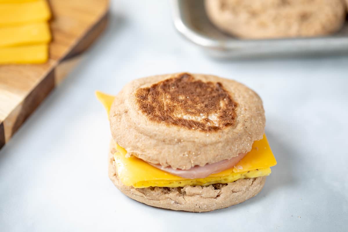 Assembled Egg, Ham and Cheese McMuffin sandwich on counter. 