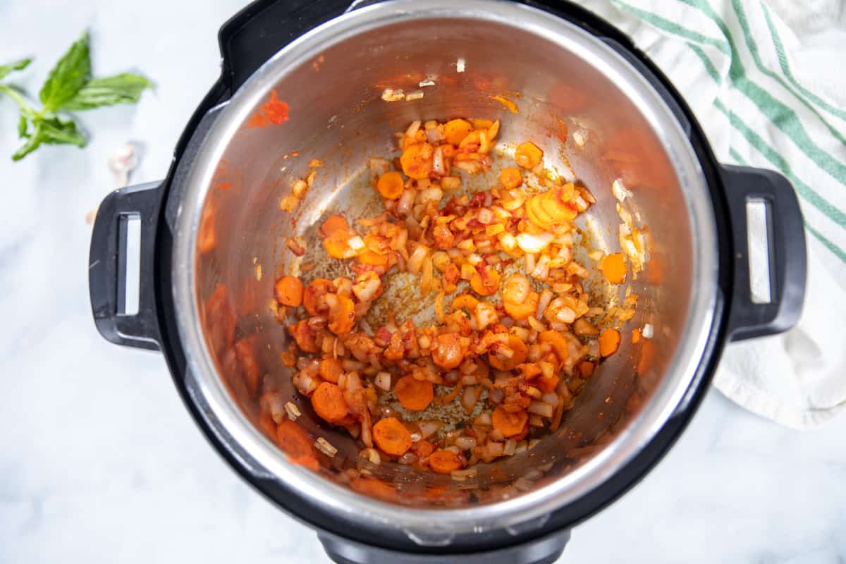 Carrots and onions sauteed in inner pot. 