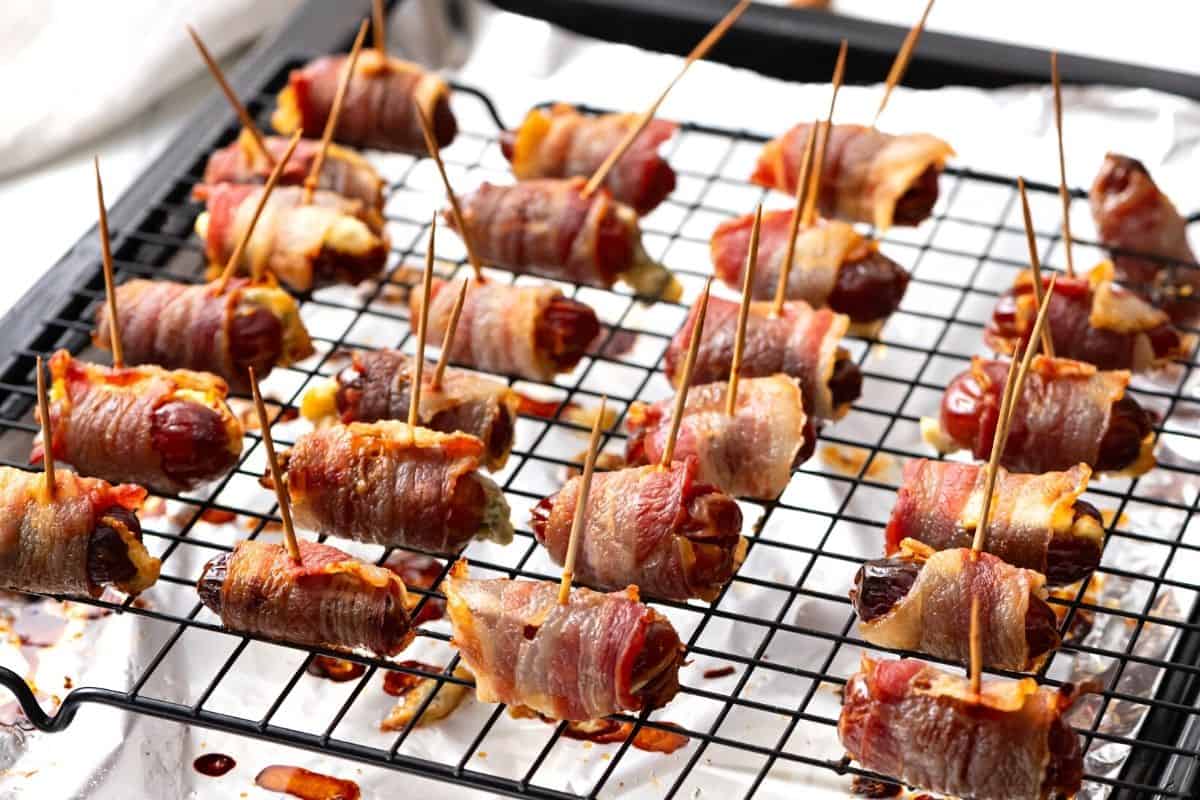 Baked bacon wrapped dates on sheet pan.