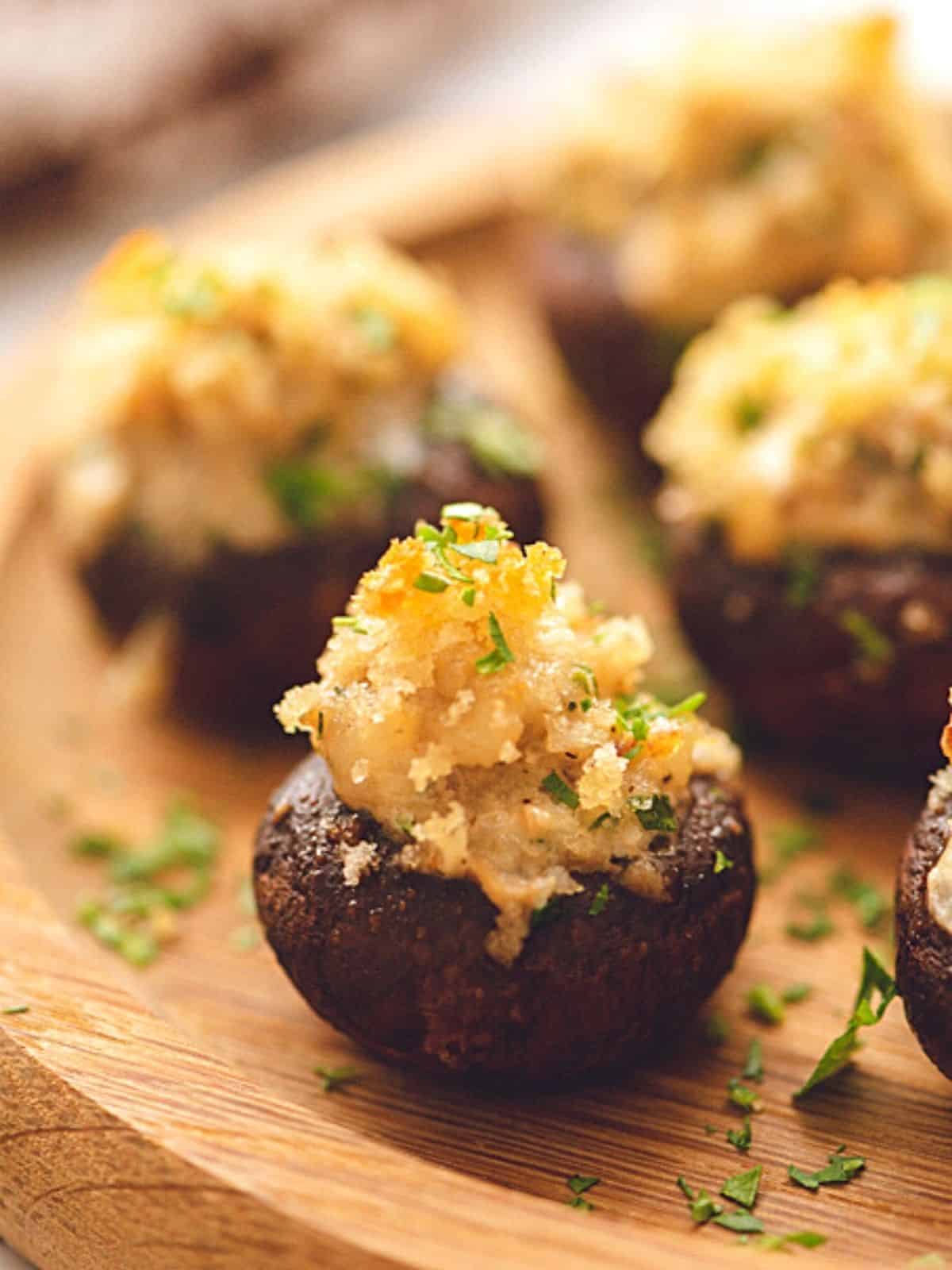 Close up of sausage and cheese stuffed mushrooms.