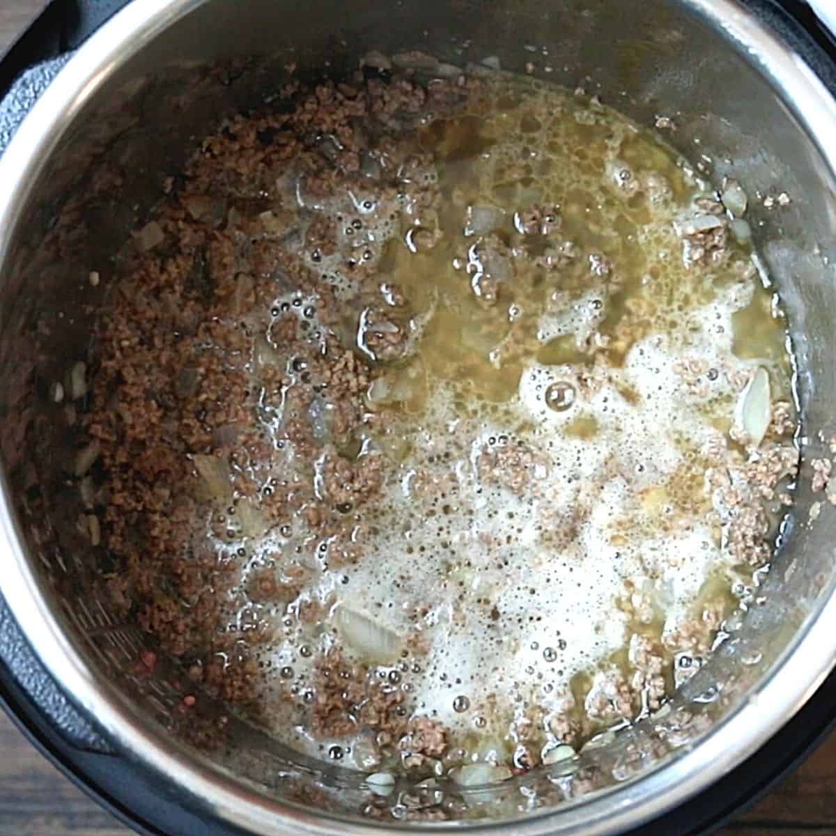 Ground beef with beef and stock insider inner pot. 
