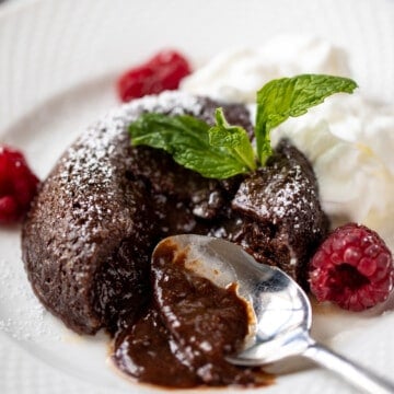 Instant Pot Lava Cake with spoon showing cutting open and chocolate oozing out.
