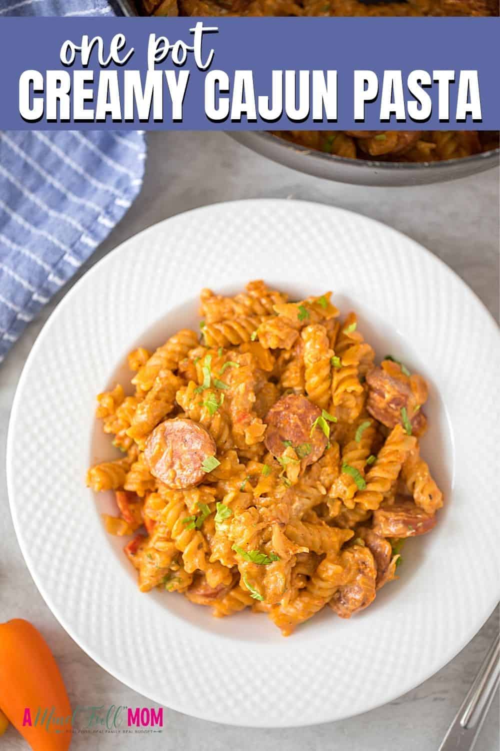Creamy Cajun Pasta is a a one pot meal made with spicy andouille sausage, peppers, onions, pasta, and a creamy, slightly spicy sauce. Ready in less than 30 minutes and in one pan, this is a perfect weeknight meal. 