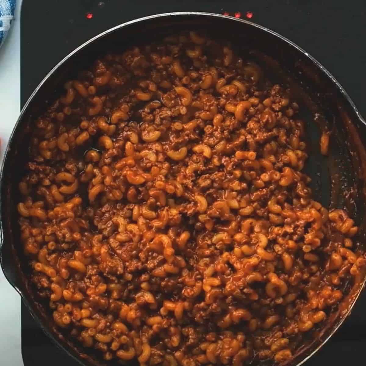 Hamburger helper in skillet with noodles that have absorbed the sauce. 