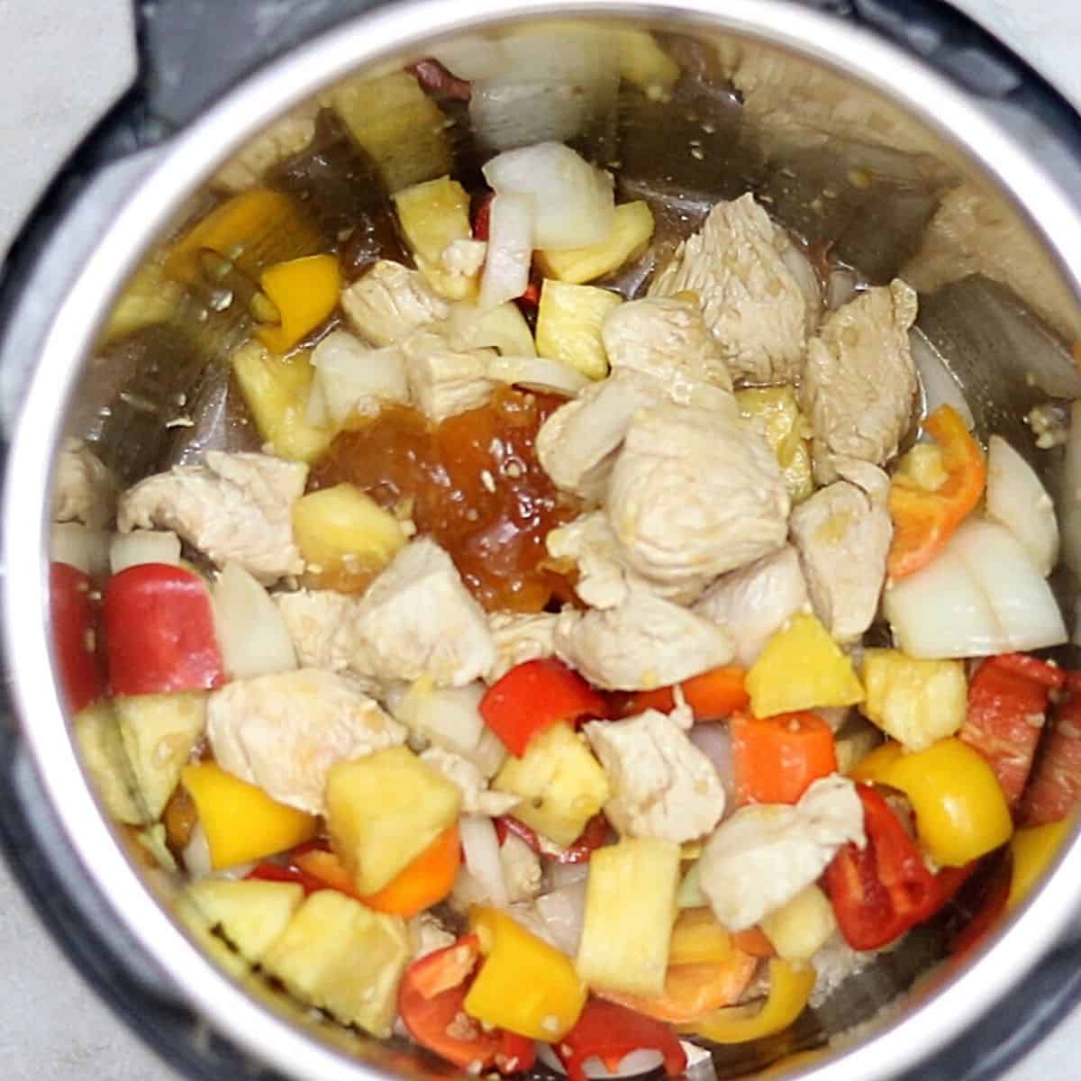 Ingredients for sweet and sour chicken inside inner pot. 